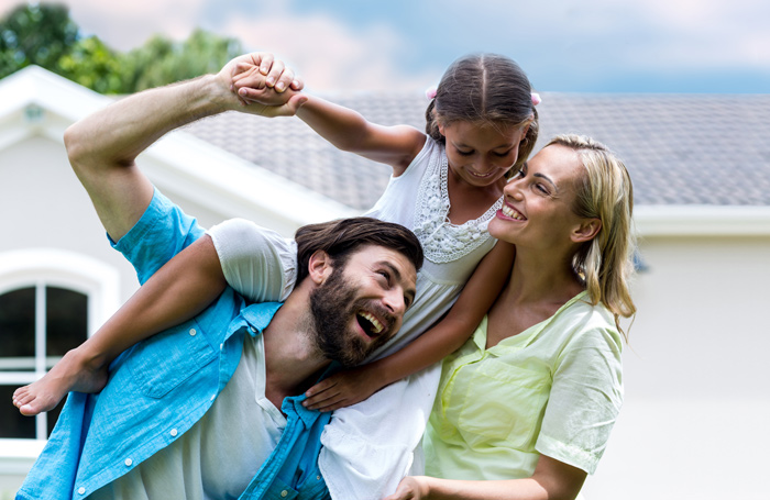 A family having fun together outside of their home.