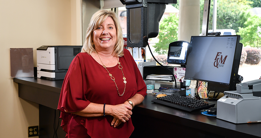 Female Teller at drive-thru window at F&M Bank