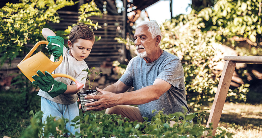 Grandparent and their grandchild in the garden.