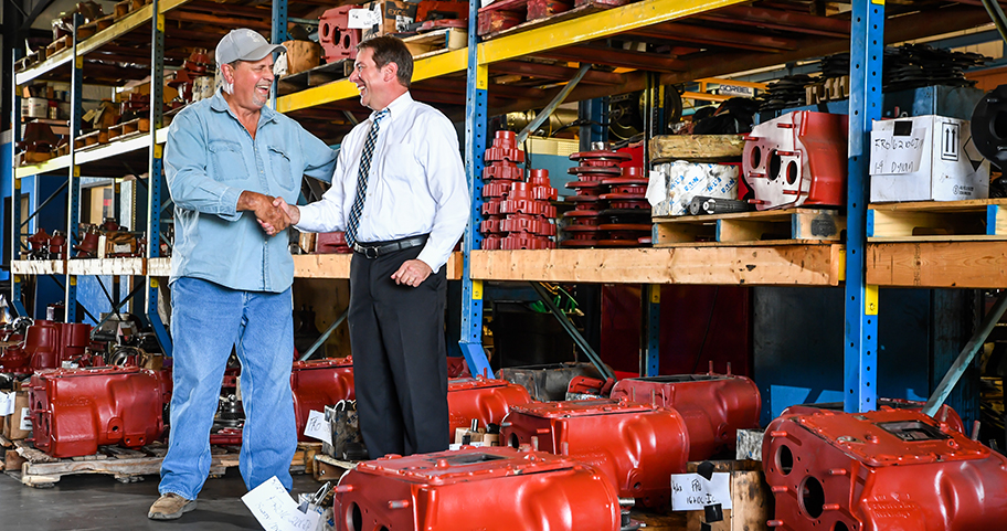 A local business owner shaking hands with a F&M Bank employee in his shop