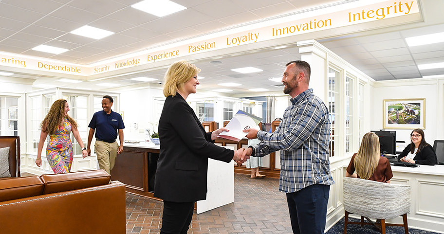 A F&M Bank employee shaking hands with a client 