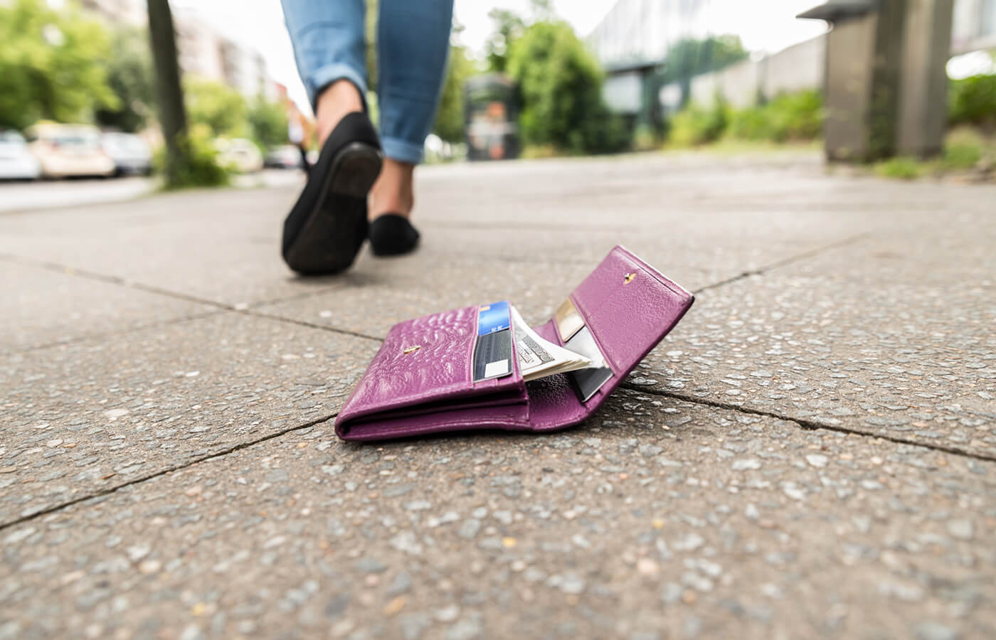 A person lost their wallet on the sidewalk.