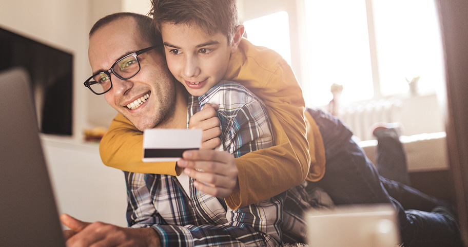 Father and son shopping online with a credit card.