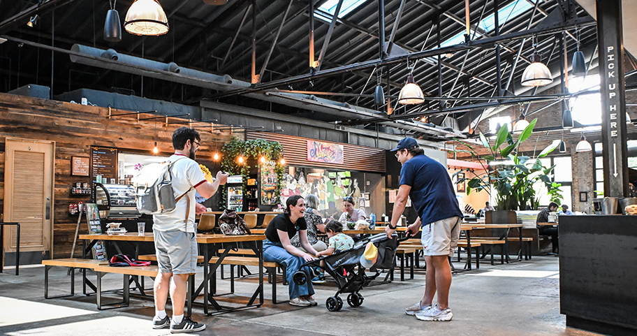 A mother and father playing with their toddler at a local restaurant.