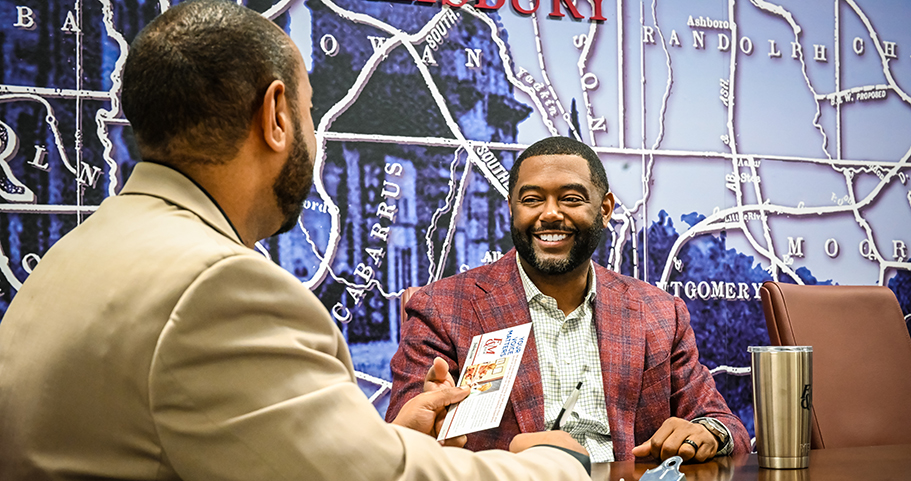 A F&M Bank employee sitting and smiling with a client