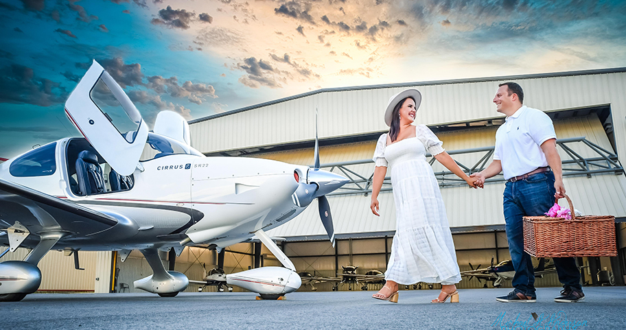 A couple walking towards their private plane at an airport