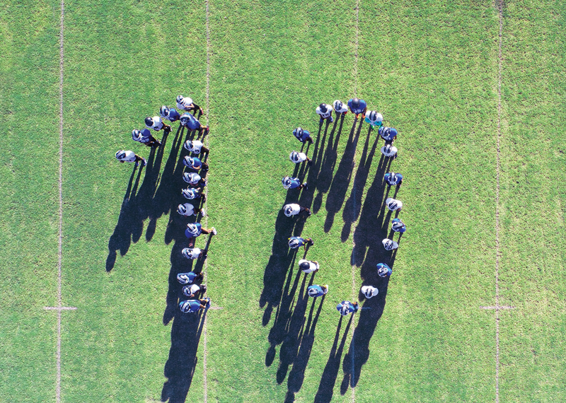 F&M Bank employees organized in the formation of the number ten on a field 