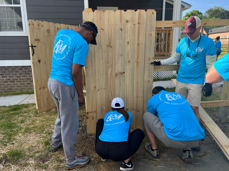 F&M Bank teammates help build a fence
