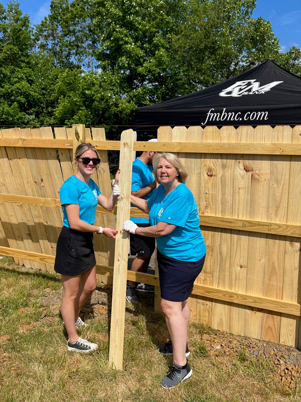 F&M teammates working together to construct a fence