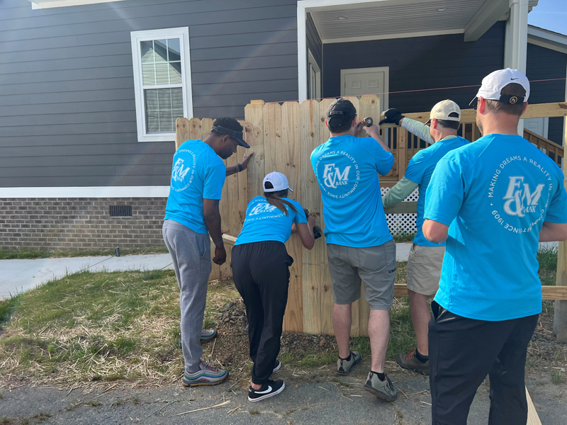 F&M Bank teammates help build a fence