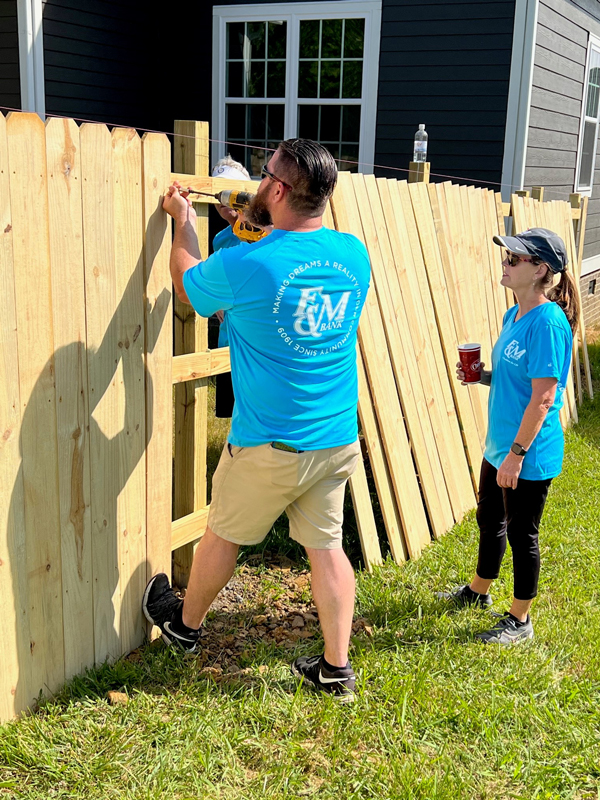 F&M Bank teammates working on building a fence