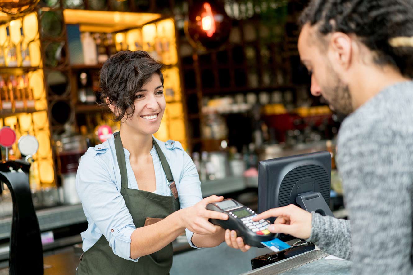 A person paying for goods at a local shop.