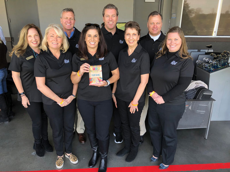 F&M Bank employees standing together holding their Best Place to Work Award