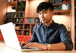 Young person using a laptop to learn about banking.