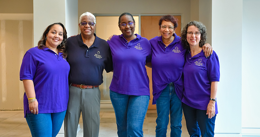 A group of business people standing together smiling