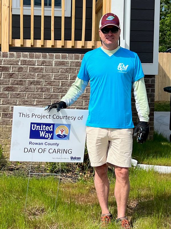 F&M Bank teammate standing next to a United Way Day of Caring sign