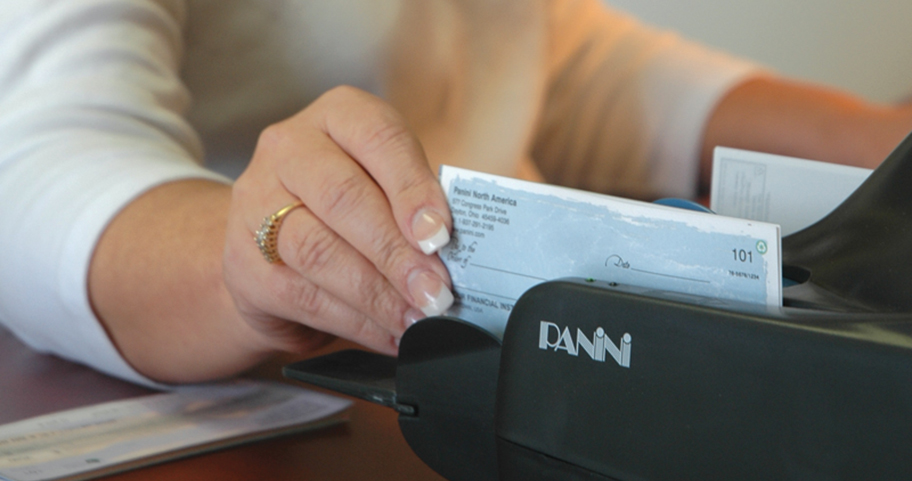 Female teller accepting a deposit at F&M Bank