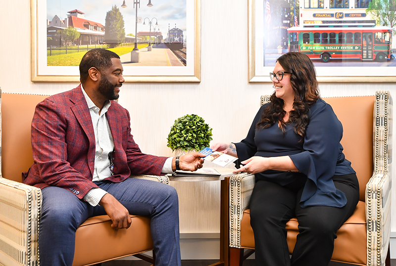 A F&M Bank employee and client talking inside the Raleigh office 