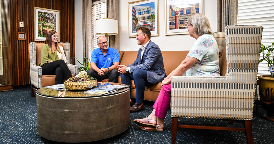 A group of people discussing investments and retirement planning at a F&M Bank office